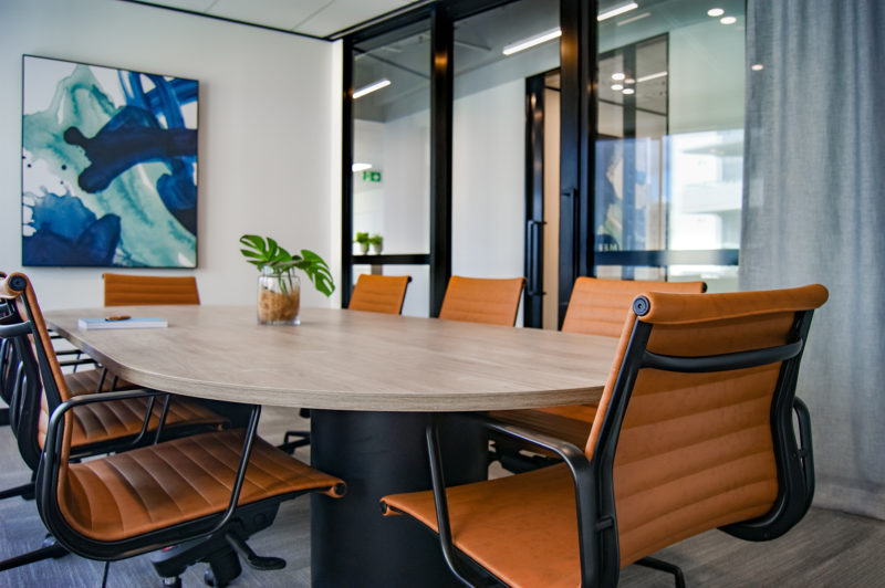 orange chairs around table in conference room