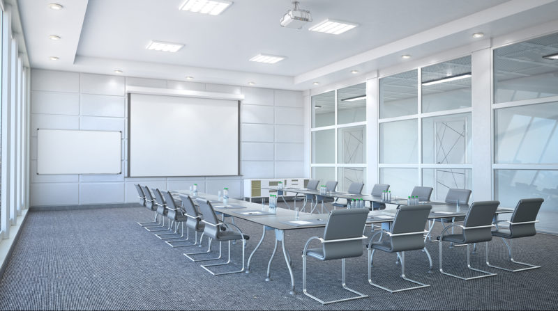 u shaped table with chairs in white conference room